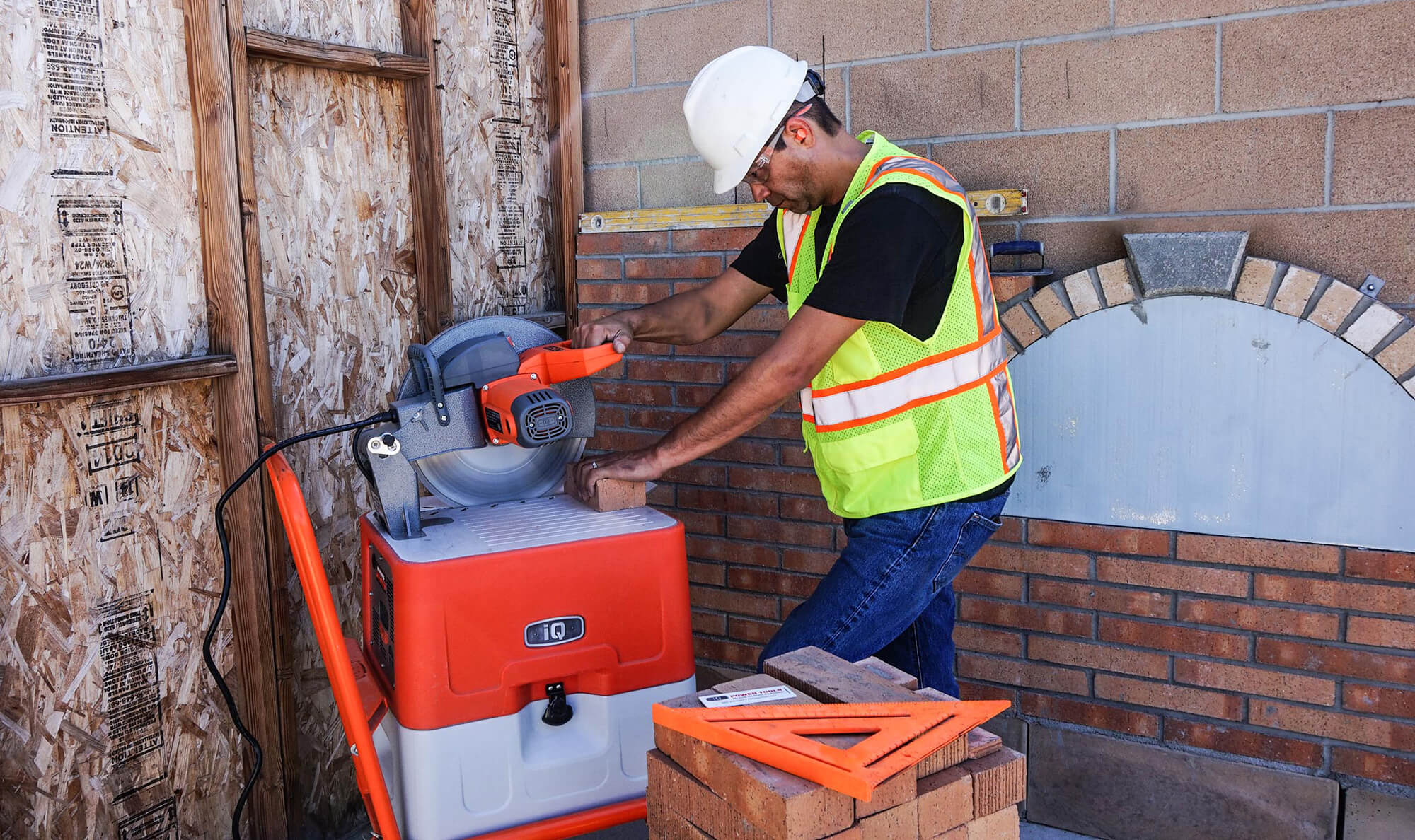 man cutting brick with saw